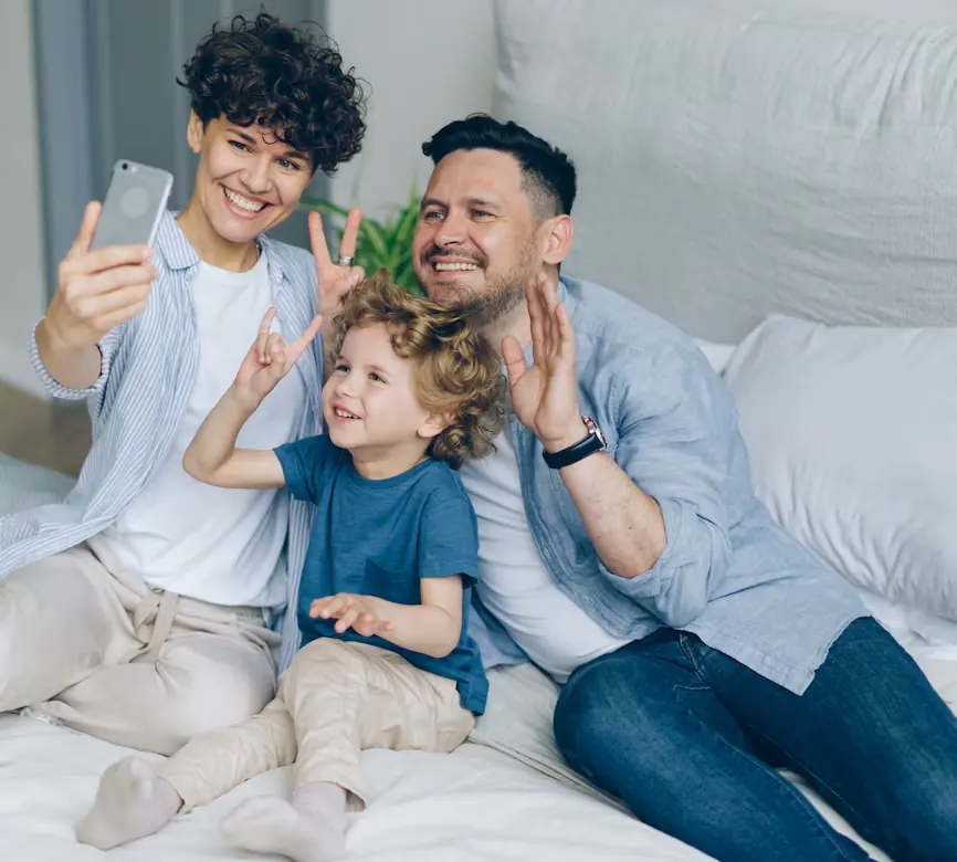 A happy family of three taking a selfie together at home